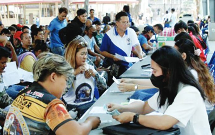 workforce cuts Workers of the Department of Social Welfare and Development distribute the P5,000 fuel subsidy to tricycle drivers during the cash relief assistance payout in Ermita, Manila on March 17, 2026. The site is one of 30 distribution sites across Metro Manila where tricycle drivers can receive their fuel subsidy from the national government. PNA PHOTO BY YANCY LIM