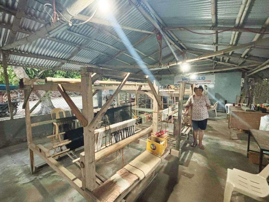 The Valladolid Looms and Weavers Association operates within Mercedes Prado-Claor’s compound in Barangay Bagumbayan, Valladolid, Negros Occidental.