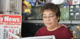 Elena Celino, 63, originally from Lonoy in Roxas City, has a newsstand at Pavia Market and has been selling newspapers for over 15 years.