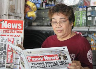 Elena Celino, 63, originally from Lonoy in Roxas City, has a newsstand at Pavia Market and has been selling newspapers for over 15 years.
