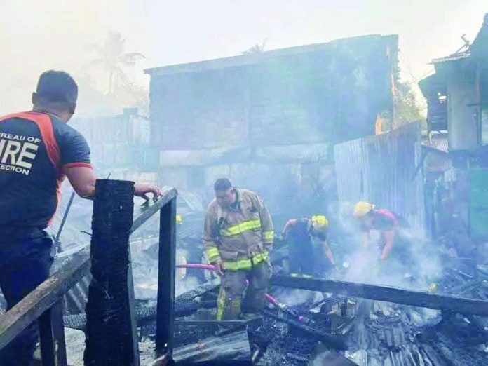 Bacolod_fire1_compressed_resized Firefighters conduct a mopping-up operation following a massive fire that tore through a residential area in Barangay 14, Bacolod City on Tuesday afternoon, April 21, 2026. Authorities reported that the blaze destroyed 22 houses and left 10 others partially damaged. BARANGAY 14 PHOTO