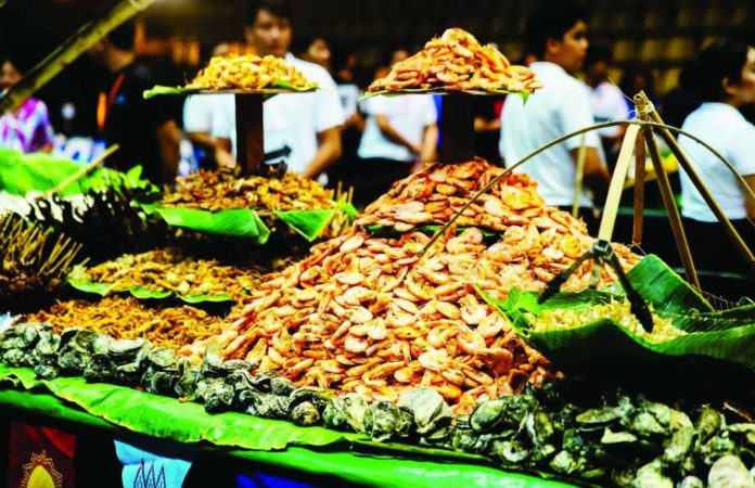 Capiz_Surambaw_copy_compressed_resized A bountiful spread of seafood—including spiced crabs, fresh shrimp, assorted mollusks, and freshly caught fish—was showcased during the Capiztahan Surambaw Seafood Feast on April 17, at the Capiz Gymnasium in Roxas City, highlighting the province’s rich marine resources and culinary traditions. CAPIZ TOURISM AND CULTURAL AFFAIRS OFFICE PHOTO