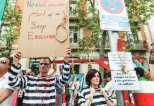 Two people dressed as hanged prisoners, with painted blood on their faces and nooses around their necks, take part in a protest against executions in Iran by opponents of the Islamic Republic, outside the US embassy of Madrid, Spain. GETTY IMAGES