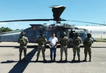 Mexican drug cartel leader found hiding in a ditch Members of Mexican Special Forces escort suspected drug cartel leader Audias Flores, known as “El Jardinero”, after his capture. Five officers are standing with their backs to the camera, to conceal their identities. Flores is facing the camera. After his capture, Flores was transported to a secure facility via helicopter. SEMAR VIA REUTERS