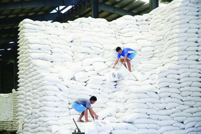 NFA_compressed_resized Workers arrange locally produce rice at the National Food Authority (NFA) warehouse in Valenzuela City, Metro Manila. INQUIRER FILE PHOTO / NIÑO JESUS ORBETA