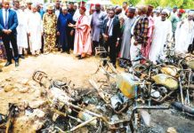 IS says it was behind deadly Nigeria attack on football pitch A group of men and officials look on at the burnt-out remnants of motorbikes Adamawa State Government I Nigeria. Gunmen have killed at least 29 people in an attack on a community in Nigeria's north-eastern Adamawa state. ADAMAWA STATE GOVERNMENT