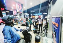 Cars and motorcycles refuel at a gasoline station in Quezon City. Misleading messages spread across social media platforms warn of a supposed power shutdown beginning April 20, prompting households to stockpile emergency supplies such as power banks, solar devices, rechargeable fans, flashlights, candles, food, medicine, and water.