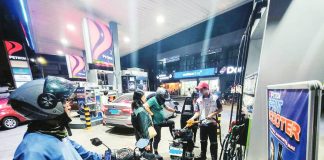 Cars and motorcycles refuel at a gasoline station in Quezon City. Misleading messages spread across social media platforms warn of a supposed power shutdown beginning April 20, prompting households to stockpile emergency supplies such as power banks, solar devices, rechargeable fans, flashlights, candles, food, medicine, and water.