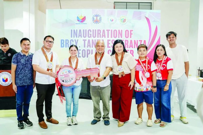 banner_pic3_compressed_resized The newly inaugurated Tanza Esperanza People’s Center, powered by a 50-kilowatt solar panel system, is the latest multiphase multipurpose building project facilitated by Iloilo City Lone District’s Rep. Julienne “Jam” L. Baronda. The P66-million facility features a green wall, and gymnasium and basketball court that doubles as an evacuation center and a dedicated space for economic enterprises to support drug rehabilitation graduates. Joining Baronda in yesterday’s inauguration ceremony were Councilor Sheen Marie Mabilog, Iloilo City District Engineering Office OIC Johnny Jose Pura, and Barangay Tanza Esperanza captain Wilbur Orada and kagawads.