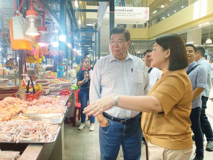 Former Senate President Franklin Drilon engages with local vendors at the Iloilo Terminal Market in Iloilo City on Tuesday, April 14, 2026. He was joined by Mayor Raisa Treñas and other city government officials. JAYMEL EIMAN/UNIVERSITY OF ANTIQUE INTERN PHOTO