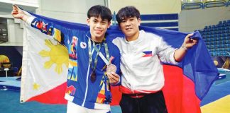Karl Eldrew Yulo (left) celebrates with a Gymnastics Association of the Philippines coach after capturing two bronze medals -- horizontal bar event and floor exercise -- at the 2026 Artistic Gymnastics World Cup. GAP PHOTO