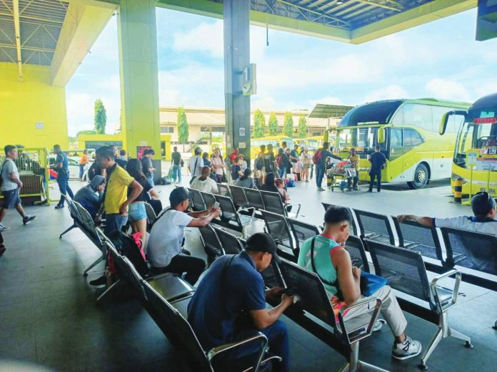 front pic Travelers begin to swarm the Ceres terminal in Jaro, Iloilo City as the annual Holy Week break begins. Under the "Oplan Ligtas Byahe" initiative, the Iloilo Police Provincial Office advises commuters to arrive early at transport terminal and bring essentials, while reminding motorists to remain alert and strictly observe traffic laws. AJ PALCULLO/PN