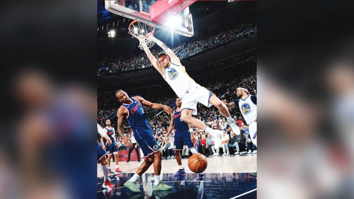 golden Golden State Warriors center Kristaps Porzingis soars for a two-handed dunk. PHOTO COURTESY OF GOLDEN STATE WARRIORS