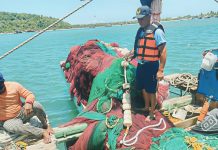 Regional Director Remia Aparri (right photo) of the Bureau of Fisheries and Aquatic Resources in Western Visayas says that while progress has been made in curbing illegal fishing across the region, some operators have resorted to “front” operations and forged permits to evade law enforcement. Left photo shows a fishing boat apprehended for illegal operations in Barangay Olotayan, Roxas City, last March. RADYO MARAGTAS PHOTO