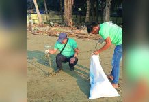 Volunteers gather coastal waste along Barangay Boulevard, Molo, Iloilo City on April 22, 2026 hauling debris into sacks as part of the Department of Environment and Natural Resources’ environmental protection drive. DENR-6