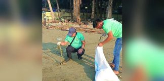 Volunteers gather coastal waste along Barangay Boulevard, Molo, Iloilo City on April 22, 2026 hauling debris into sacks as part of the Department of Environment and Natural Resources’ environmental protection drive. DENR-6