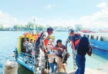 Philippine Coast Guard personnel assist passengers from Guimaras Island as they disembark from a motorboat upon arrival at a wharf in Iloilo City. Authorities are intensifying port operations for the Holy Week travel surge. PCG-ILOILO PHOTO