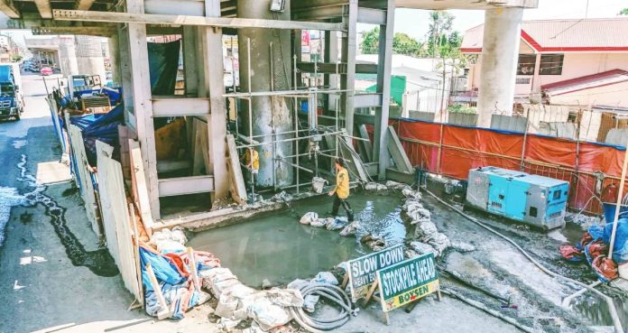 AGANAN FLYOVER REHAB IN FULL SWING. Workers navigate pooled water beneath the structure as foundation strengthening and grouting works continue on the long-delayed Aganan Flyover in Pavia, Iloilo, part of efforts to fast-track completion after three years of stoppage. DPWH-6 PHOTO