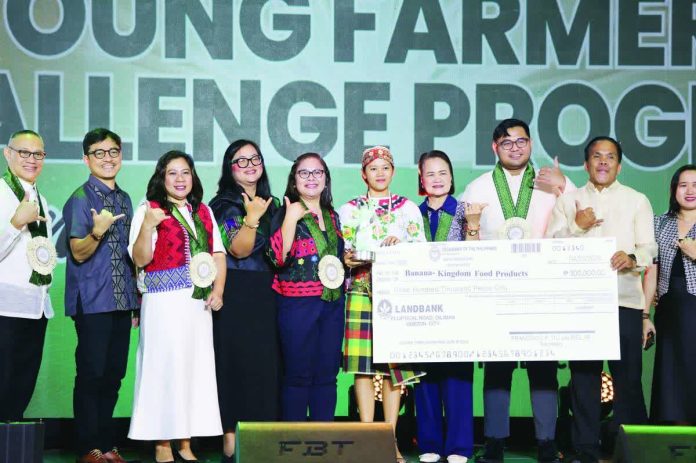 ime_young_farmers_compressed_resized_resized_compressed AWARD-WINNING AGRIPRENEUR. Joy C. Saban of Lambunao, Iloilo, representing Banana Kingdom Food Products, receives her award and P300,000 cash prize after placing 3rd in the Start-Up Component (Food Processing Category) of the Young Farmers Challenge Program Season 5 National Pitching Competition in Iloilo City. DA-6