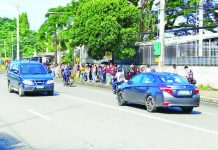 Commuters outside the bus terminal in Barangay Camalig, Jaro, Iloilo City endure the midday sun in this file photo. The city government plans to install cooling centers in high-traffic public spaces, particularly transport waiting areas such as plazas, to provide relief to commuters during peak heat hours. PN FILE PHOTO
