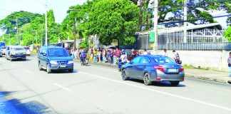 Commuters outside the bus terminal in Barangay Camalig, Jaro, Iloilo City endure the midday sun in this file photo. The city government plans to install cooling centers in high-traffic public spaces, particularly transport waiting areas such as plazas, to provide relief to commuters during peak heat hours. PN FILE PHOTO