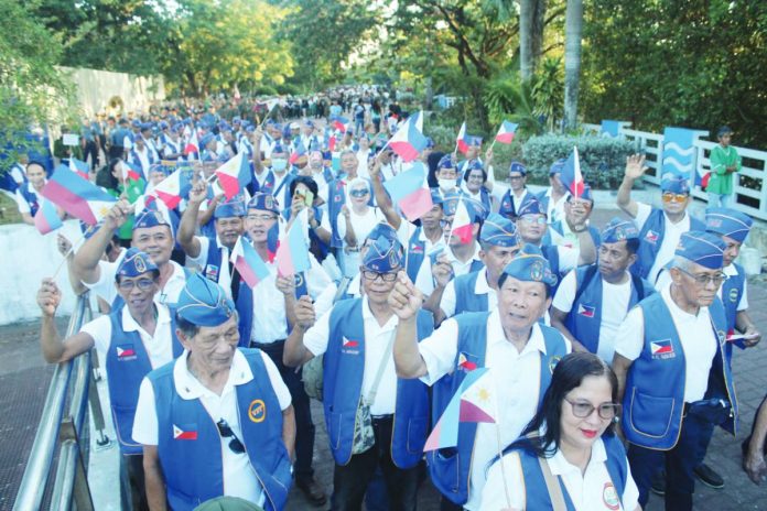 neljoy Valor1 Veterans, reservists, and youth cadets wave Philippine flags as they take part in a Freedom March during the 84th Araw ng Kagitingan commemoration at the University of the Philippines Visayas in Iloilo City, highlighting a renewed push to instill patriotism among younger generations. AJ PALCULLO/PNP