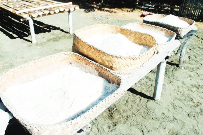 neljoy salt industry TRADITION IN CRYSTALS. Freshly harvested salt from the traditional “budbud” method is laid out in woven trays in Miag-ao, Iloilo. This centuries-old craft traces back to 1823, when the town produced up to 10,000 sacks annually and sustained generations of local salt makers. PN PHOTO