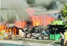RAGING INFERNO. Fire engulfs a residential structure in Barangay Purok II, Pavia, Iloilo on Sunday morning, April 19, 2026, rapidly spreading to nearby establishments as thick smoke billows into the sky. The blaze, fuelled by strong winds and extreme heat, caused over P224,000 in damage and prompted renewed calls from authorities for the public to report fires immediately instead of filming the incident for social media. AJ PALCULLO/PN