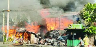 RAGING INFERNO. Fire engulfs a residential structure in Barangay Purok II, Pavia, Iloilo on Sunday morning, April 19, 2026, rapidly spreading to nearby establishments as thick smoke billows into the sky. The blaze, fuelled by strong winds and extreme heat, caused over P224,000 in damage and prompted renewed calls from authorities for the public to report fires immediately instead of filming the incident for social media. AJ PALCULLO/PN