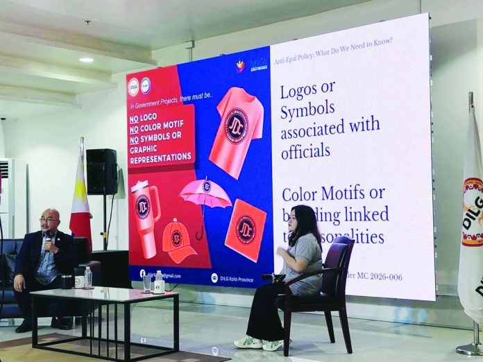 neljoy_epal_DILG_copy_compressed_resized Regional Director Juan Jovian Ingeniero (left) of the Department of Interior and Local Government – Western Visayas briefs the public on the prohibition against self-promotion in government projects during an Anti-Epal Policy orientation in Iloilo City. The stage backdrop shows some of the specific prohibitions. NELJOY GALIGAO/PN