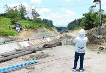 A project engineer inspects ongoing construction of the high line canal of the Jalaur River Multi-Purpose Project Stage II in Calinog, Iloilo. The National Irrigation Administration is fast-tracking construction amid improved weather conditions. NIA-6