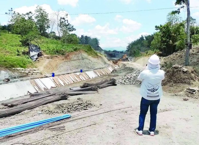 neljoy_high_line_canal_copy_compressed_resized A project engineer inspects ongoing construction of the high line canal of the Jalaur River Multi-Purpose Project Stage II in Calinog, Iloilo. The National Irrigation Administration is fast-tracking construction amid improved weather conditions. NIA-6