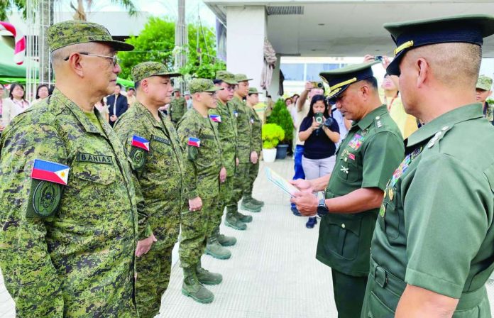 neljoy_reserve_Army_copy_compressed_resized Formally joining the Philippine Army Reserve, Iloilo’s Gov. Arthur Defensor Jr. (second from left) and other provincial officials (Provincial Administrator Raul Banias, Provincial Population Office head Atty. Ruel Von Superio, Atty. Artem Ron Raymundo, Charles Lemeric, Leobert Pinuela, and Gerry Mae Alcoriza) receive their certificates and serial numbers during a flag-raising ceremony at the Iloilo Provincial Capitol after completing their training.