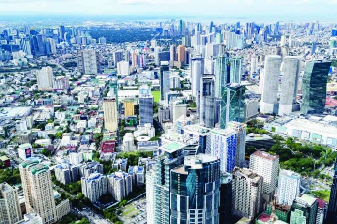 High-rise buildings in the Ortigas Business District in Pasig City looms large in the horizon as seen through a drone shot. The Bangko Sentral ng Pilipinas reported that a nationwide survey of 515 firms showed the business confidence index tumbled to -24.3 percent in March from 8.2 percent in February 2026. FILE PHOTO BY GRIG C. MONTEGRANDE | INQUIRER