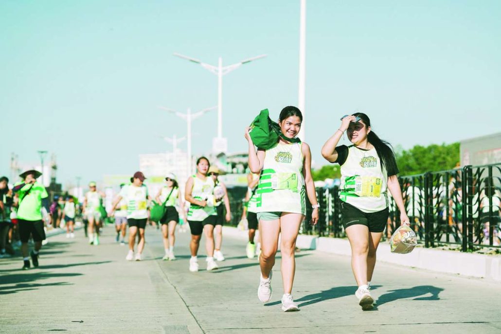 Smiles and conversation are seen along the route as runners carry items gathered throughout the Puregold Hakot Relay.
