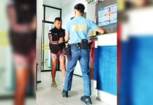 GRUDGE TURNS DEADLY: Suspect in fatal work-related shooting now in police custody; faces murder, frustrated murder charges Lloyd Katipunan (left) is currently in the custody of the Pavia, Iloilo Municipal Police Station, awaiting formal charges of murder and frustrated murder. AJ PALCULLO/PN