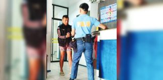 Lloyd Katipunan (left) is currently in the custody of the Pavia, Iloilo Municipal Police Station, awaiting formal charges of murder and frustrated murder. AJ PALCULLO/PN
