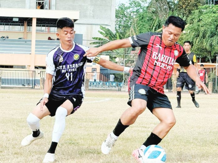 sportd Barotac Harold Bayona of Barotac Nuevo controls the ball against the defense of Jovanie Simpron from Sta. Barbara, Iloilo. CONTRIBUTED PHOTO