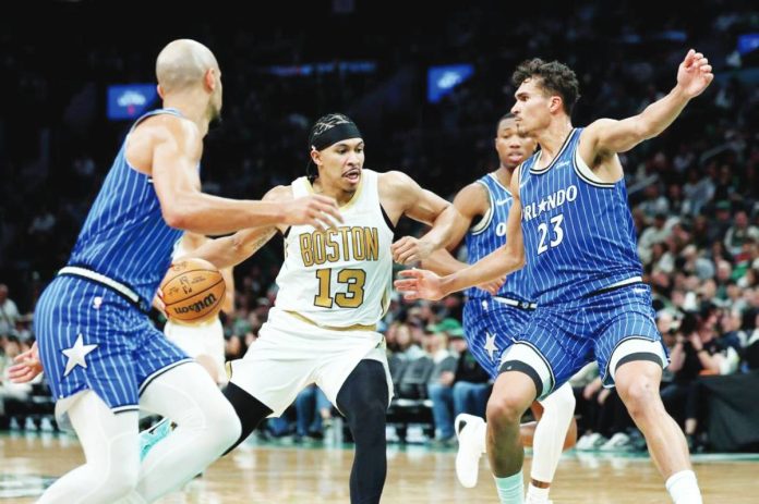 sports Harper copy Boston Celtics forward Ron Harper Jr. (13) drives to the net as Orlando Magic forward Tristan da Silva (23) defends. AP PHOTO/MARK STOCKWELL