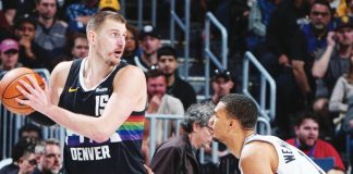 Denver Nuggets center Nikola Jokic sizes up San Antonio Spurs' Victor Wembanyama. GETTY IMAGES