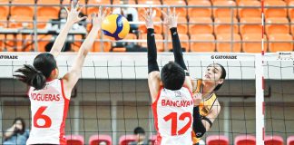 University of Santo Tomas Golden Tigresses’ Angeline Poyos scores against the defense of University of the East Lady Warriors. UAAP PHOTO