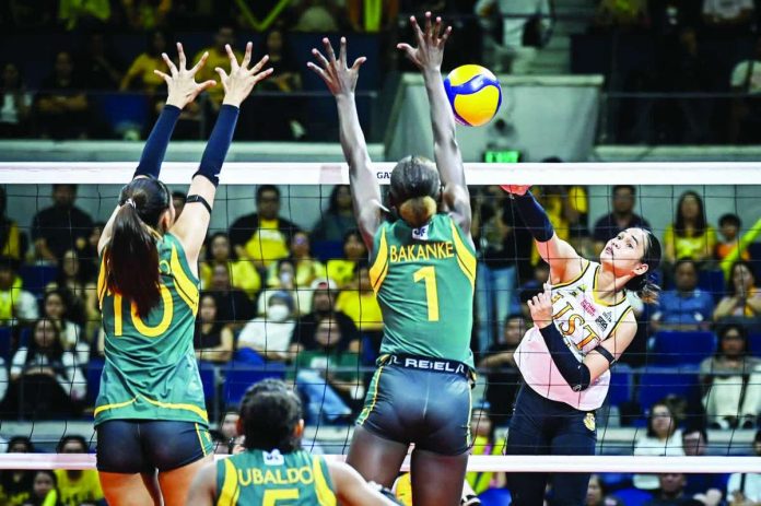 sports_UST_compressed_resized University of Santo Tomas Golden Tigresses' Angeline Poyos scores against the defense of Faida Bakanke of Far Eastern University Lady Tamaraws. UAAP PHOTO
