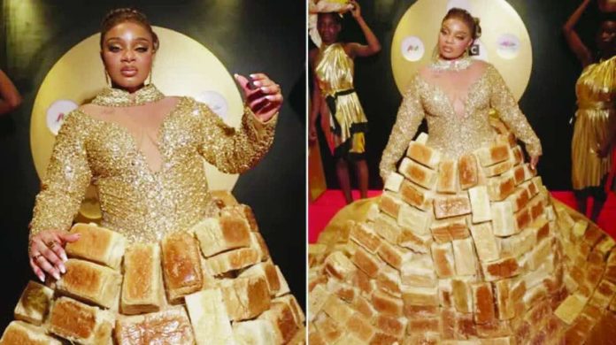 Africa’s reality TV star Queen Mercy Atang is seen with her dress made from loaves of bread. BBC/GIFT UFUOMA