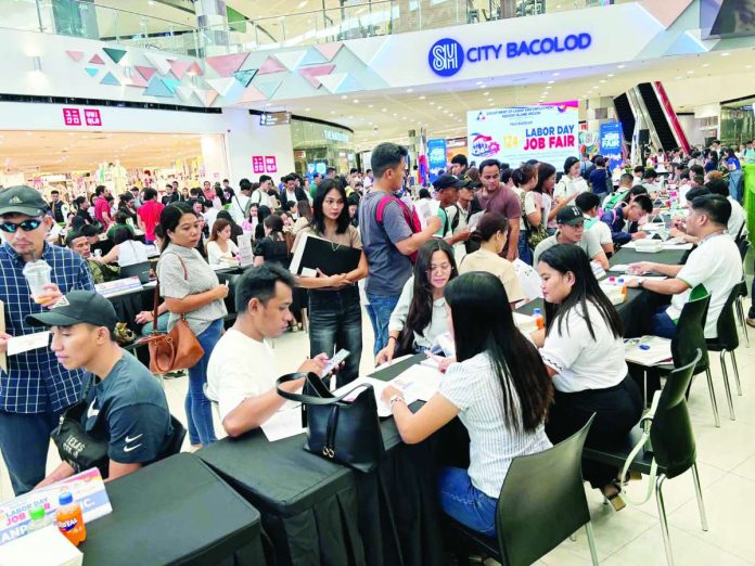 Bacolod_job_fair_copy_compressed_resized Job seekers crowded the main atrium of SM City Bacolod on May 1, 2026, as they explored employment opportunities during the Labor Day job fair organized by DOLE-NIR and the Bacolod City Government. MAE SINGUAY/PN