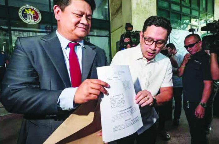 Bank_glitch_copy_compressed_resized Lawyer Manases “Mans” Carpio (right), husband of Vice President Sara Duterte-Carpio, appears before the Quezon City Prosecutor’s Office on April 27, 2026 with his counsel, Peter Paul Danao, to file a complaint against officials of the Bangko Sentral ng Pilipinas, the Anti-Money Laundering Council, and House lawmakers over disclosures on his finances during hearings related to the impeachment of his wife. PHOTO BY GRIG C. MONTEGRANDE | INQUIRER