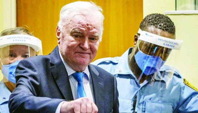 Bosnia_copy_compressed_resized Former Bosnian Serb military chief Ratko Mladić arrives in the courtroom prior to the hearing of the final verdict on appeal against his genocide conviction over the 1995 Srebrenica massacre. Mladić has been in detention since 2011 and lost his appeal 10 years later. AFP VIA GETTY IMAGES