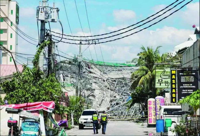 Building_collapse.JPG_resized Police authorities cordon off the area surrounding a collapsed nine-story building in Barangay Balibago, Angeles City, Pampanga, on Sunday, May 24, 2026. While rescue workers have successfully pulled more than 20 individuals from the rubble, search and rescue efforts remain underway during the critical hours following the disaster, with an estimated 30 to 40 people still believed to be trapped. INQUIRER PHOTO / GRIG C. MONTEGRANDE