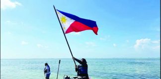 NO JOKE. Akbayan party-list’s Cong. Dadah Kiram Ismula arrives by jet ski at Pag-asa Cay 2 (Sandy Cay) on Sunday, May 3, 2026, and raises high the Philippine flag. This was the Atin Ito activist coalition’s fourth mission to the West Philippine Sea, challenging China’s trespassing into Philippine waters. PHOTO FROM THE ATIN ITO COALITION