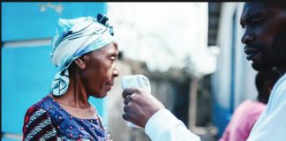 A man holds a contactless infrared thermometer close to a woman's face. The World Health Organization says Ebola virus has spread beyond the Democratic Republic of Congo, with two confirmed cases reported in neighboring Uganda. AFP VIA GETTY IMAGES