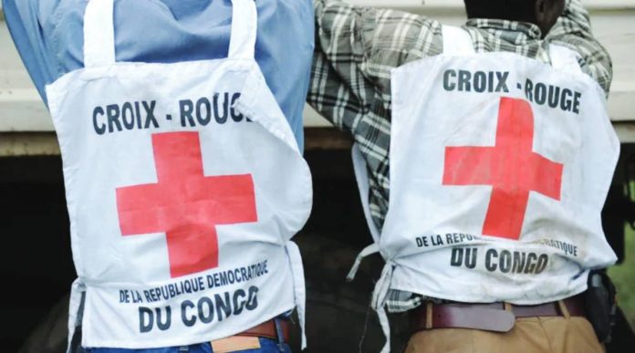 Congo Two individuals are pictured from behind wearing Red Cross tabards. The tabards read “croix-rouge de la republic Democratique du Congo”. The volunteers are thought to have been infected before the outbreak had been identified, the Red Cross said. AFP VIA GETT IMAGES
